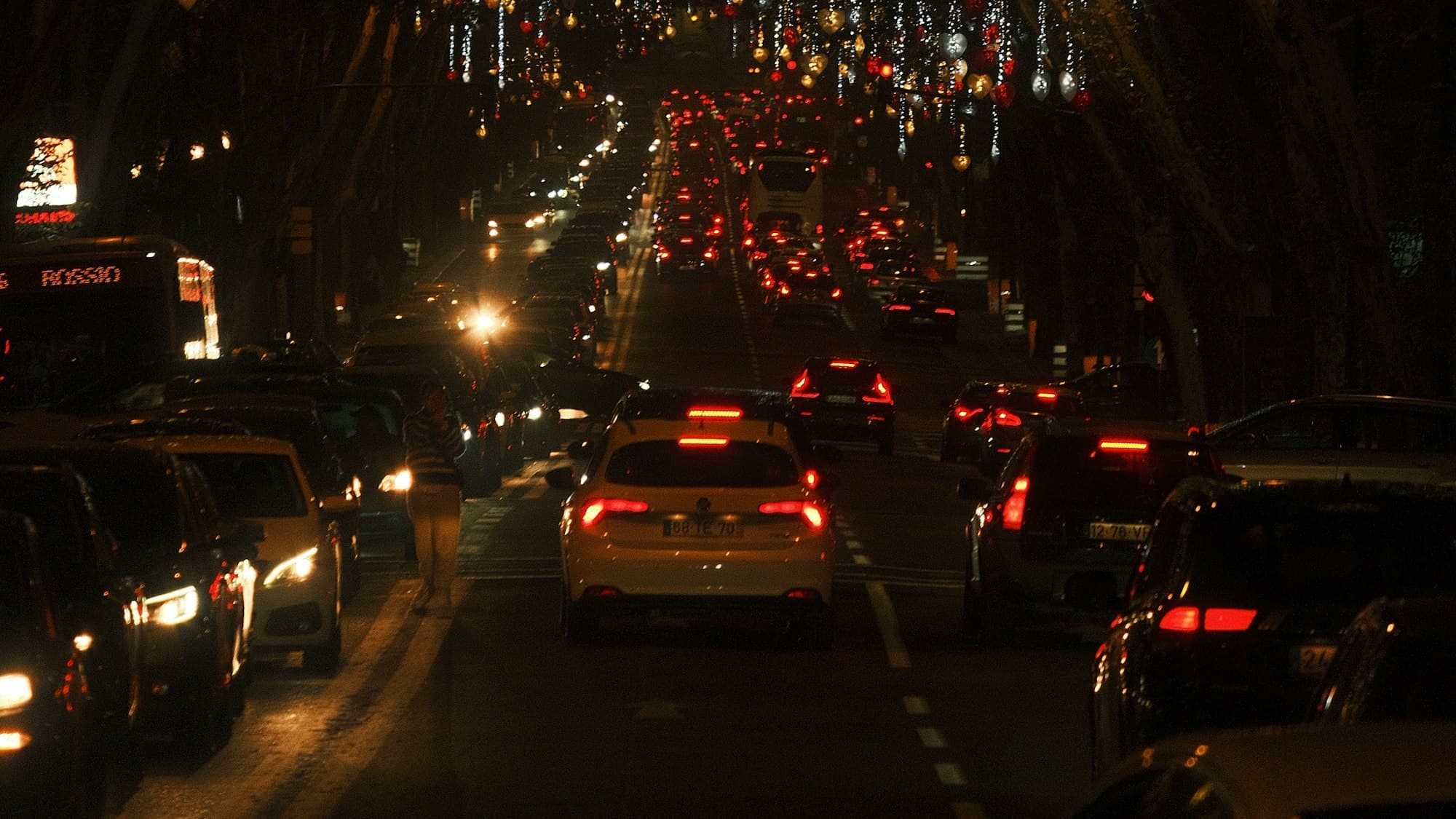 A Lisbon street lined with overhead Christmas lights at night, Portugal