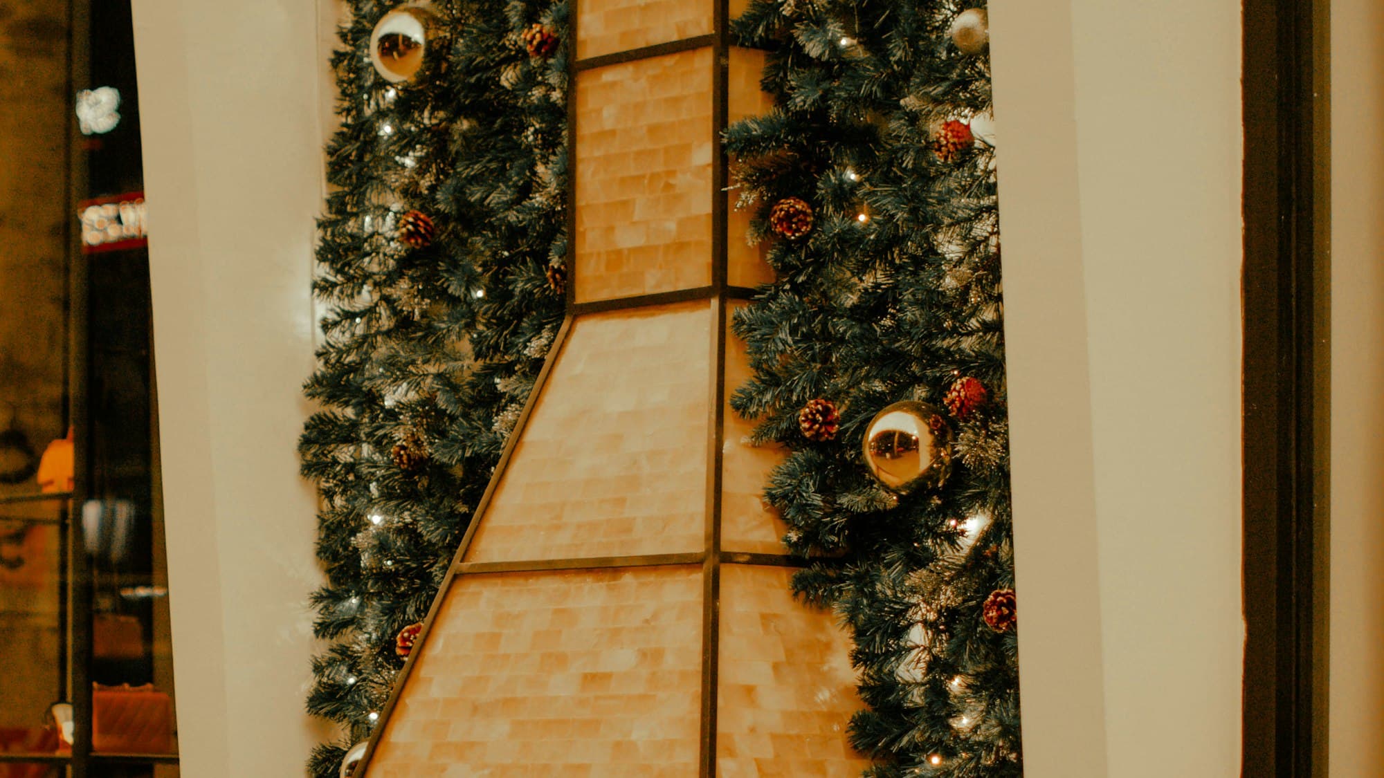 A tall decorated Christmas tree on a street in Ho Chi Minh City, Vietnam, at night